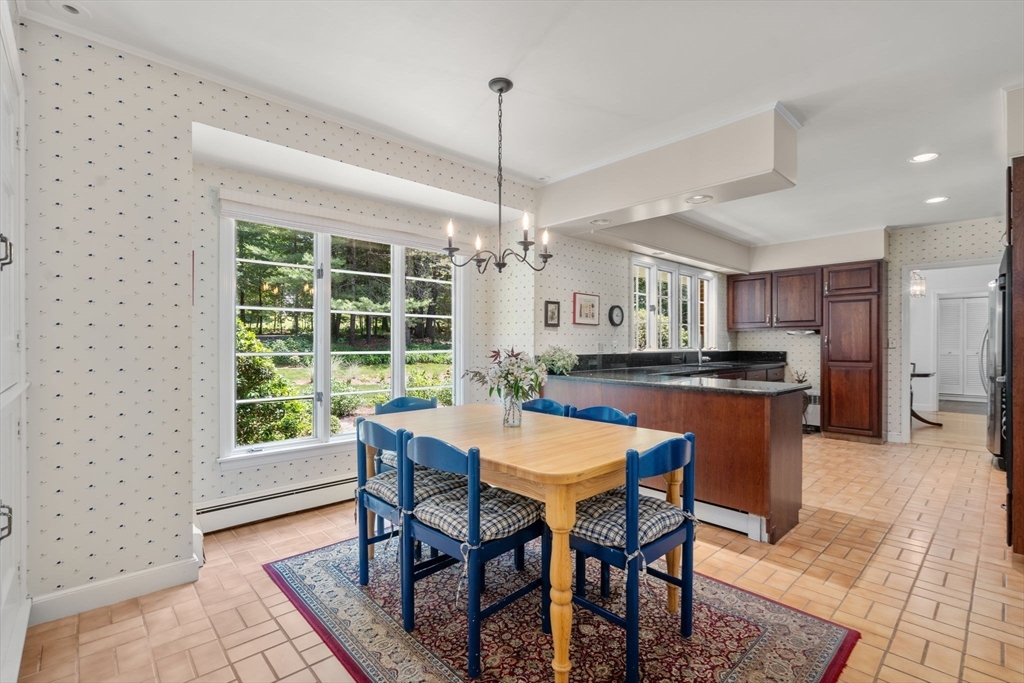 62 Mill Street Sherborn, MA 01770 - Photo 9 of 36 a dining room with a table chairs and kitchen view