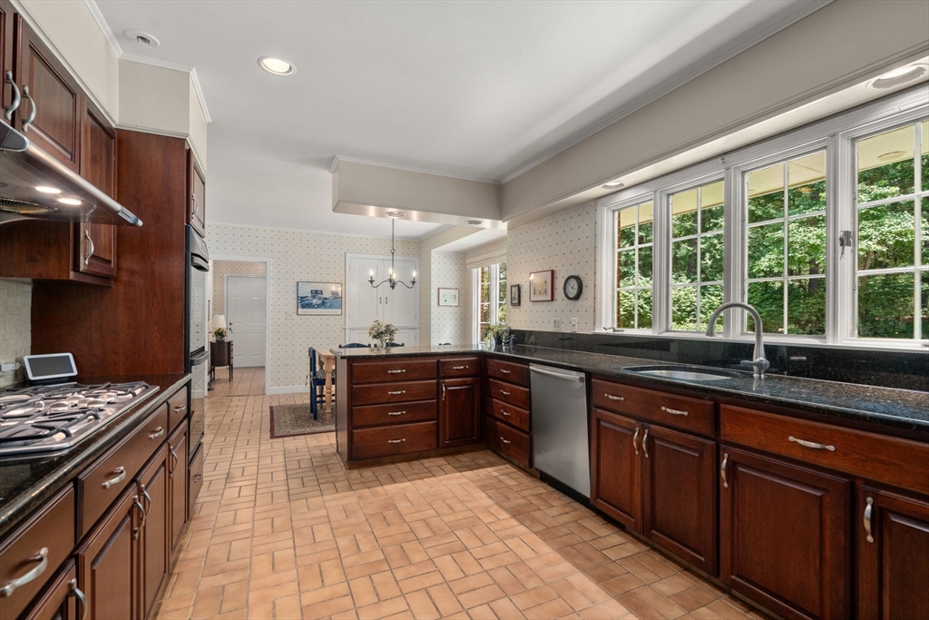 62 Mill Street Sherborn, MA 01770 - Photo 10 of 36 a kitchen with granite countertop a sink stove and cabinets