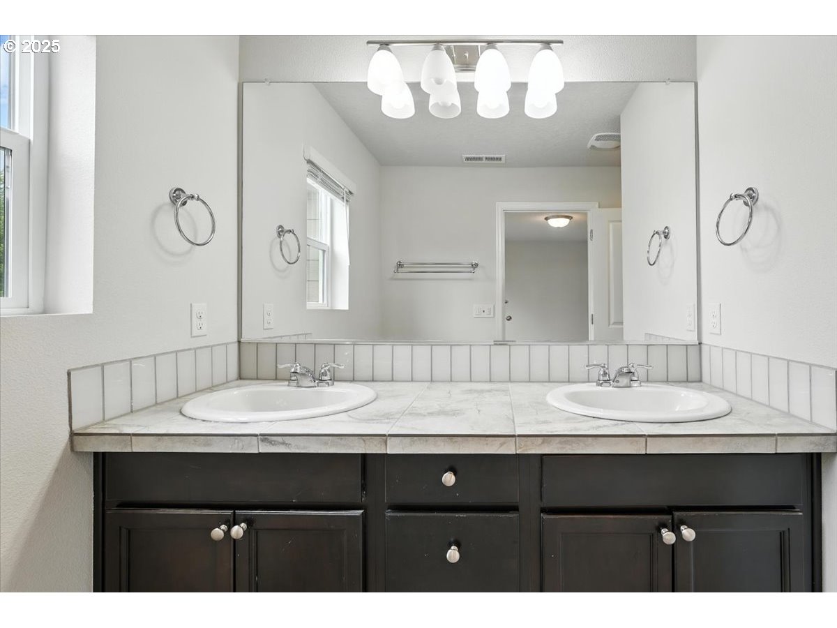 2103 Southeast 18th Alley Gresham, OR 97080 - Photo 11 of 25 a bathroom with a sink vanity and a mirror