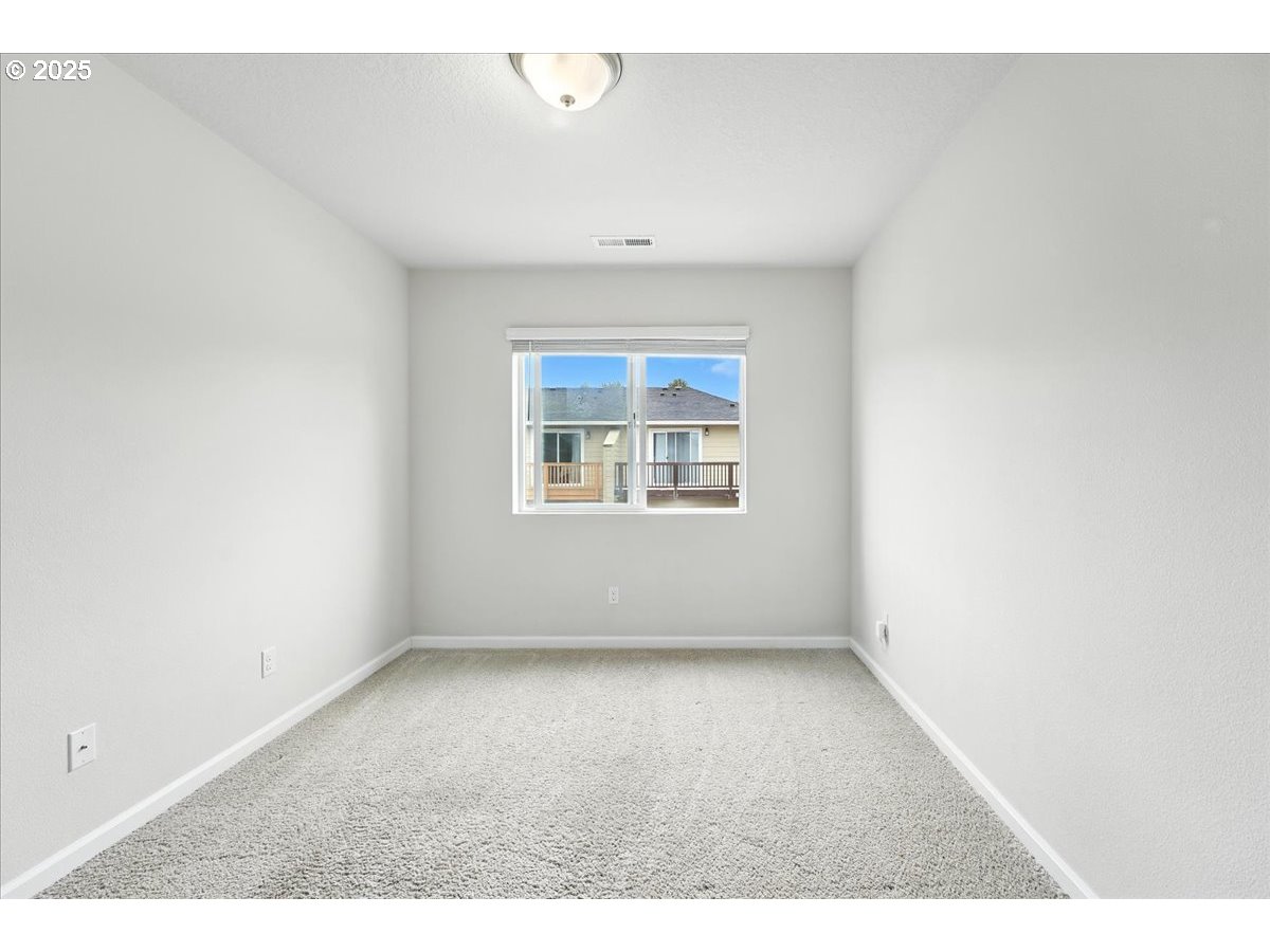 2103 Southeast 18th Alley Gresham, OR 97080 - Photo 13 of 25 an empty room with windows