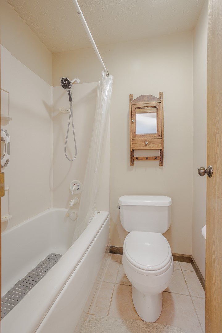540 Basil Street Springboro, OH 45066 - Photo 19 of 32 This clean and inviting bathroom features tile flooring, a shower-tub combination, and a functional toilet.