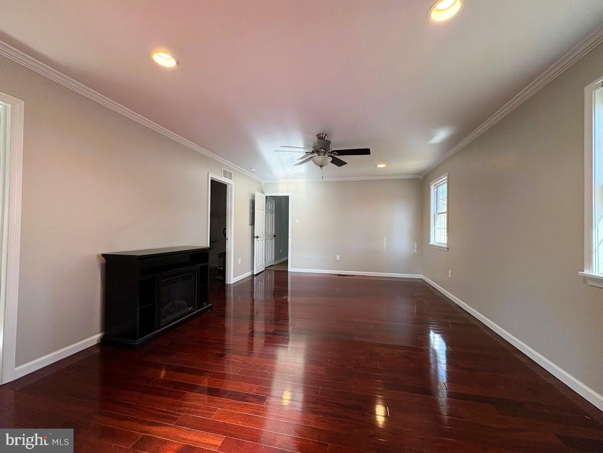 7 Ridgewood Road Gibbsboro, NJ 08026 - Photo 21 of 33 a view of an empty room with wooden floor ceiling fan and a window