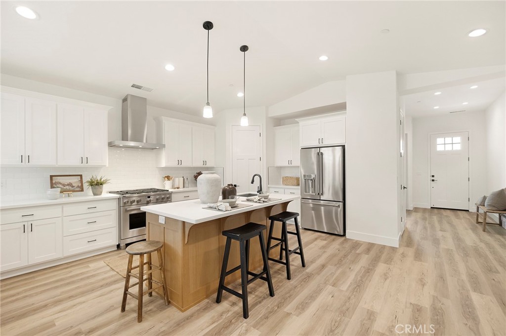 22 Harkness Court Chico, CA 95973 - Photo 14 of 49 a kitchen with stainless steel appliances kitchen island hardwood floor sink and stove