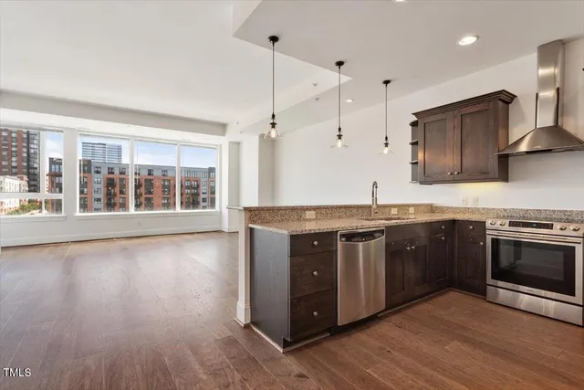 a kitchen with stainless steel appliances granite countertop a stove and a sink
