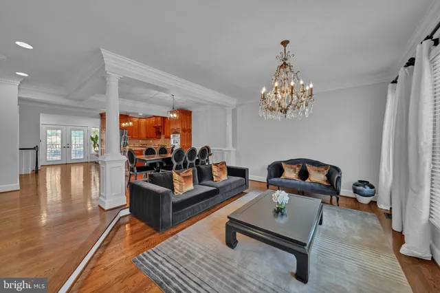 a living room with furniture and a chandelier