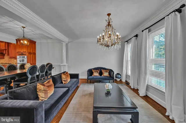a living room with furniture and a chandelier