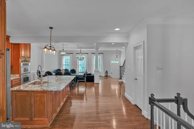 a living room with furniture and a painting on the wall