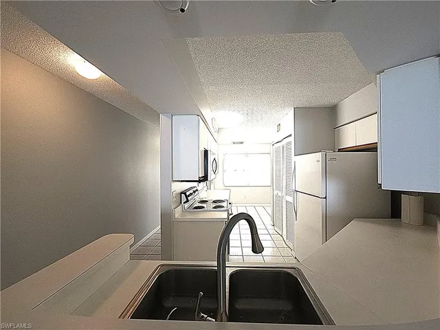 a view of a kitchen with a refrigerator washer and dryer