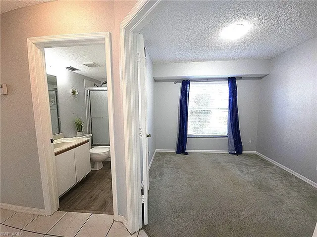 a view of a hallway with bathroom and bathroom