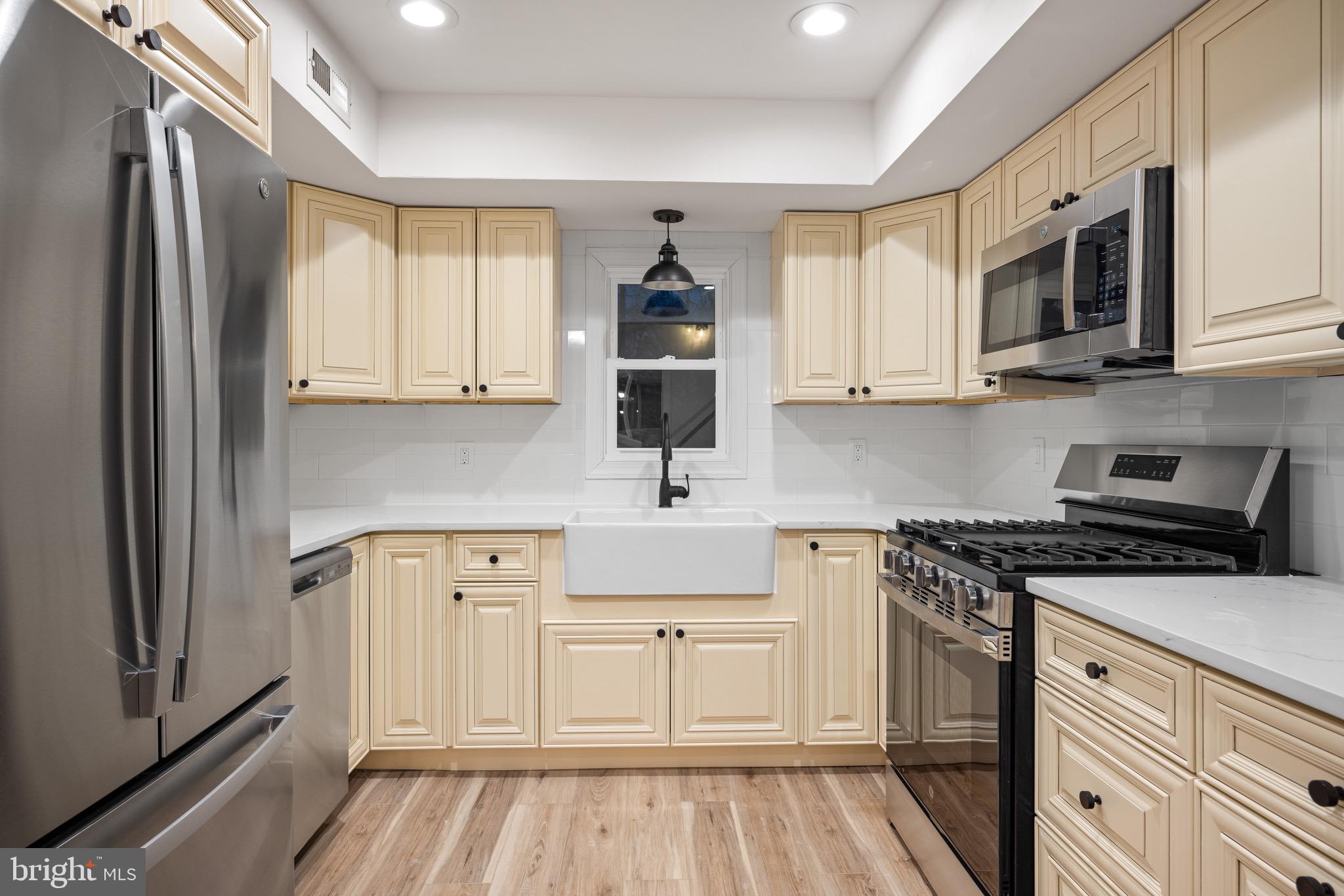 1711 Janvier Road Williamstown, NJ 08094 - Photo 11 of 24 a kitchen with stainless steel appliances granite countertop a stove a sink and a microwave