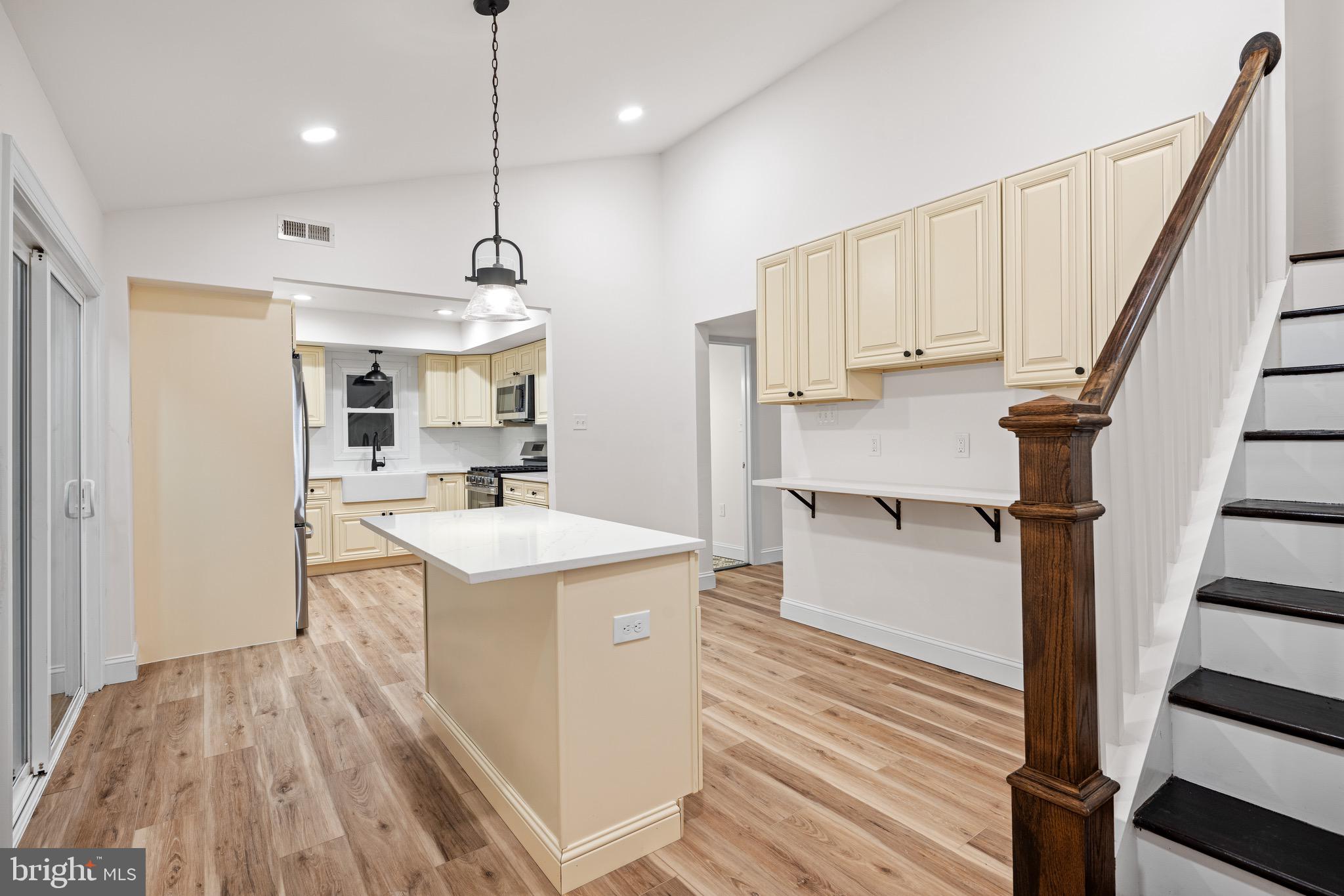 1711 Janvier Road Williamstown, NJ 08094 - Photo 12 of 24 a open kitchen with kitchen island white cabinets and white appliances