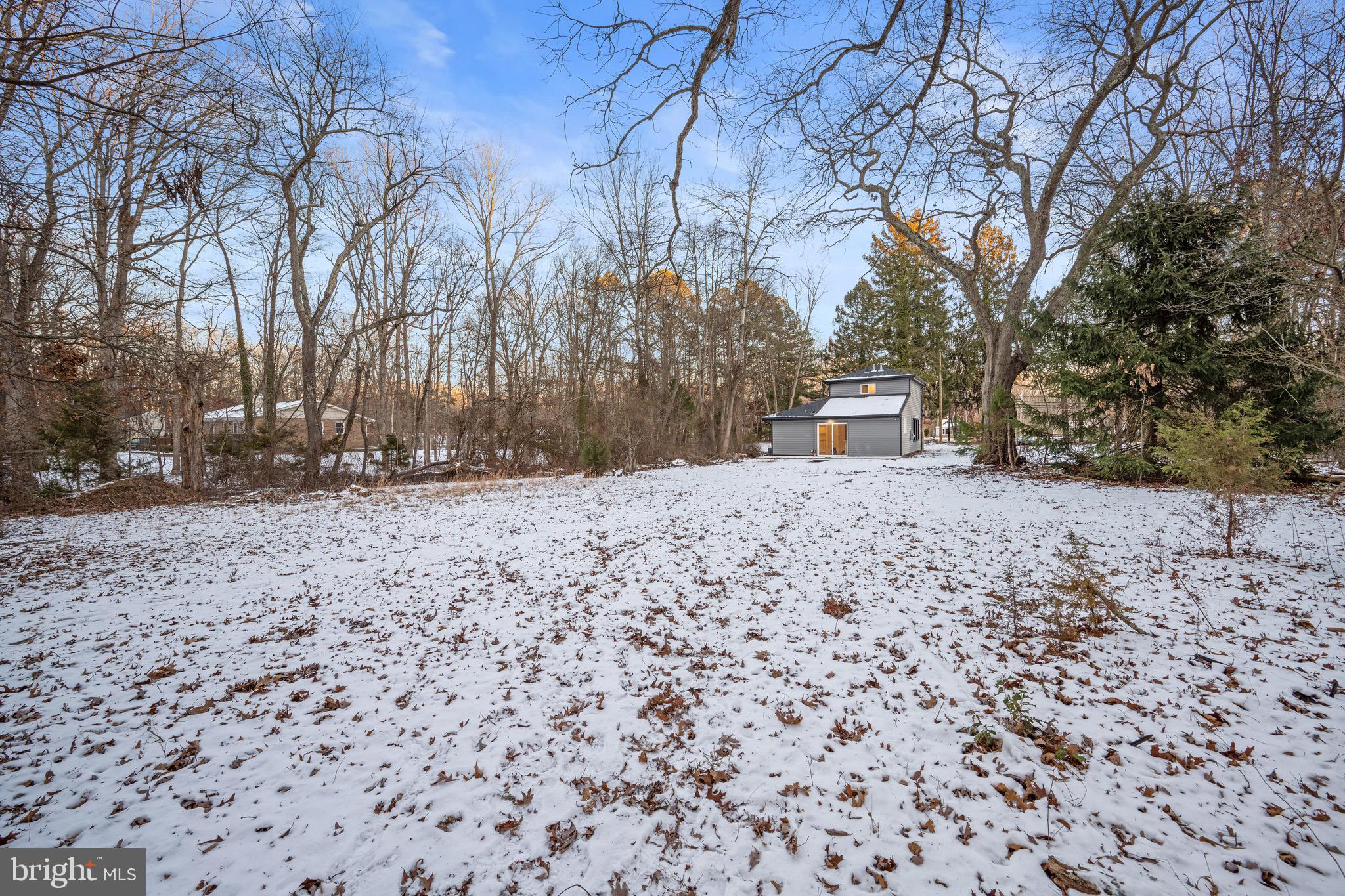 1711 Janvier Road Williamstown, NJ 08094 - Photo 18 of 24 a view of white house with a yard covered with snow