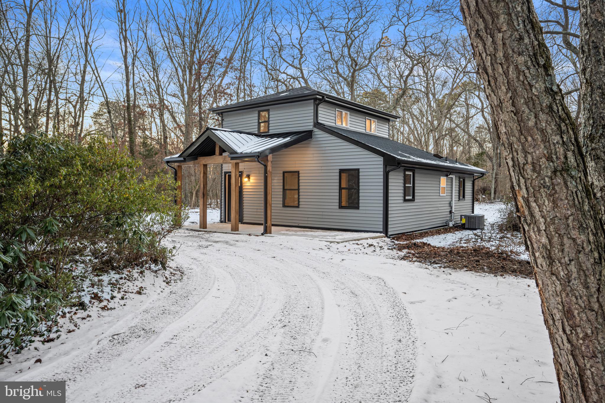 1711 Janvier Road Williamstown, NJ 08094 - Photo 3 of 24 a view of a house with a yard covered in snow