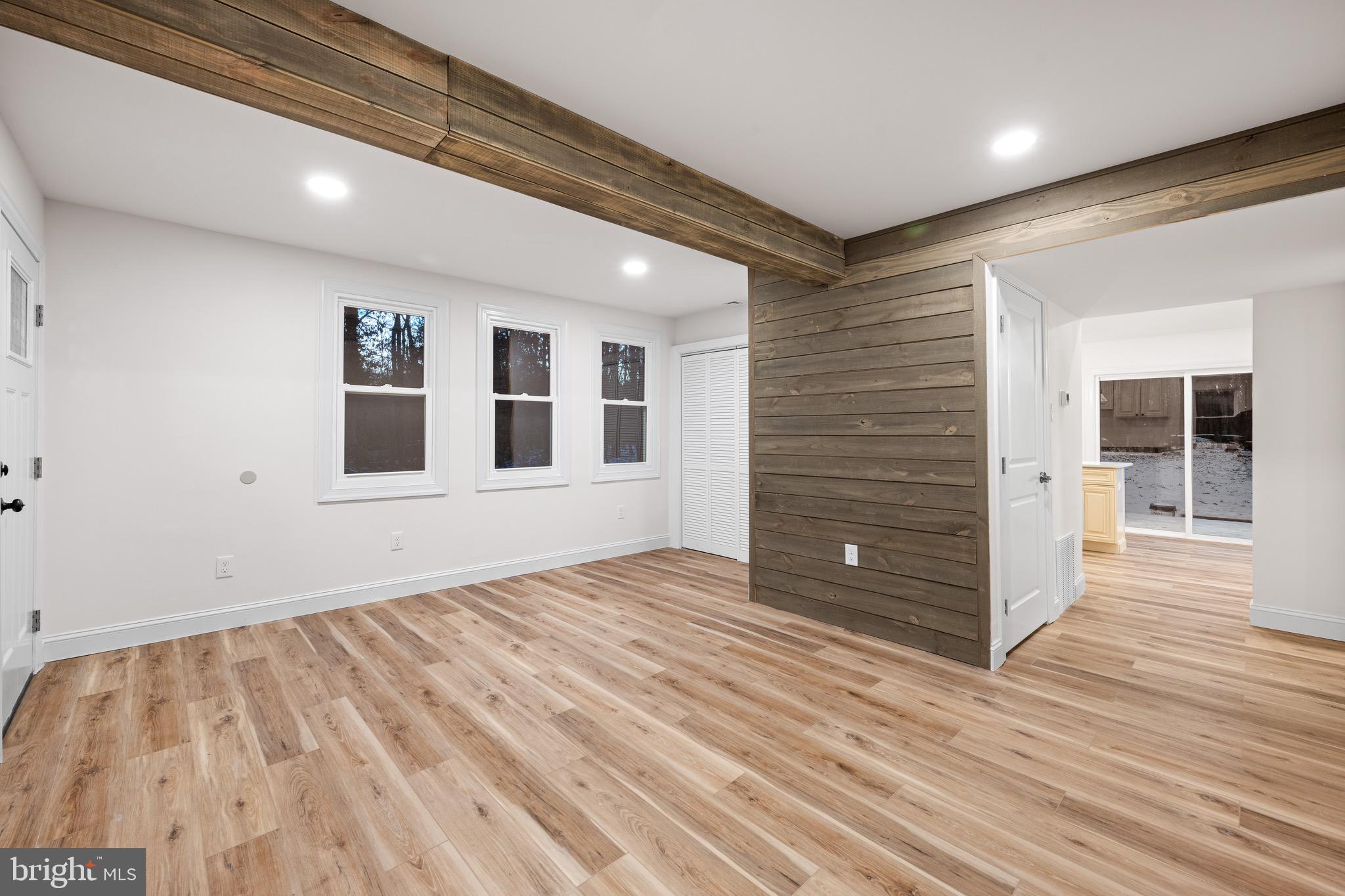 1711 Janvier Road Williamstown, NJ 08094 - Photo 4 of 24 a view of an empty room with wooden floor and a window