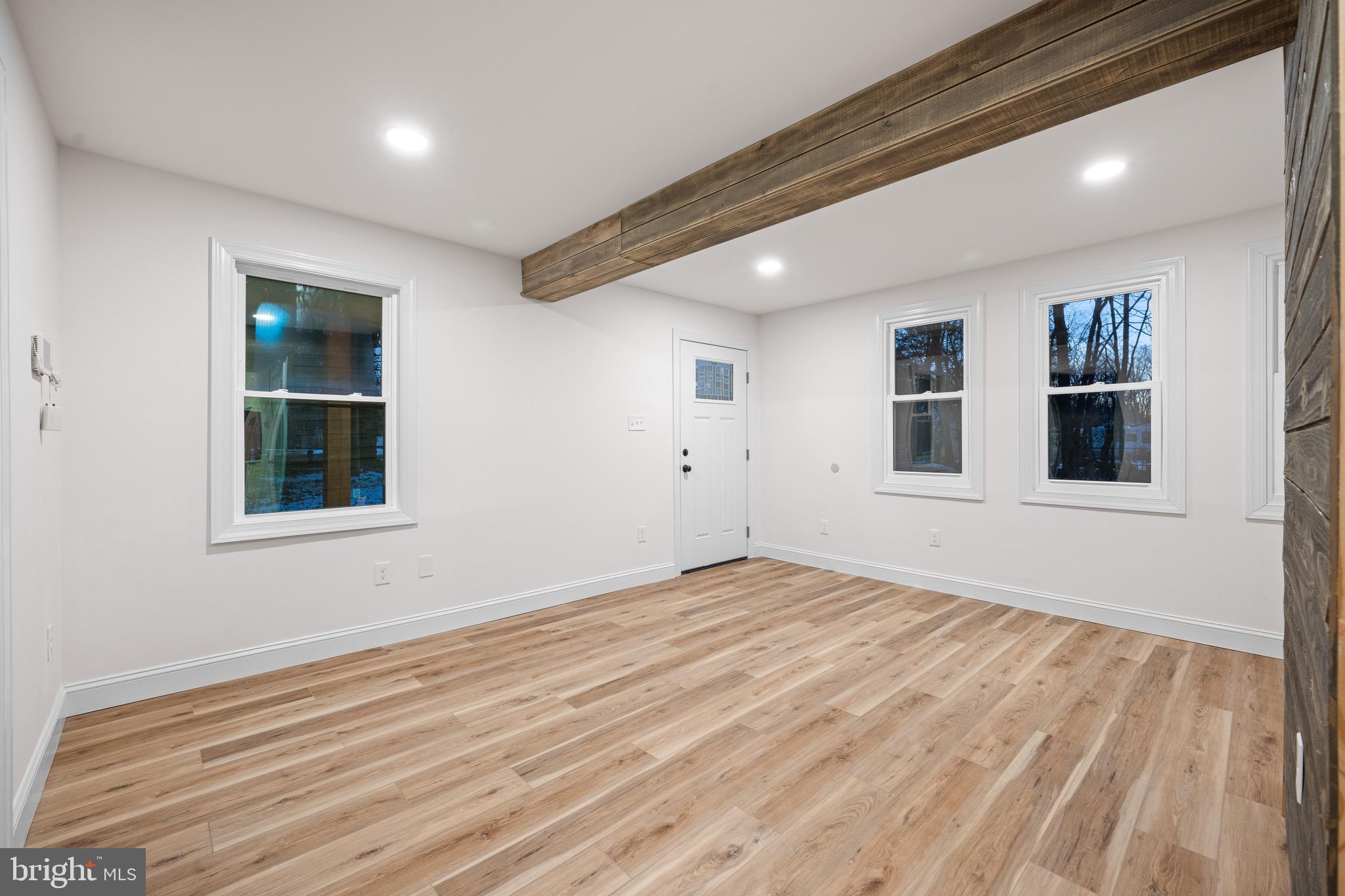1711 Janvier Road Williamstown, NJ 08094 - Photo 6 of 24 a view of empty room with wooden floor and windows