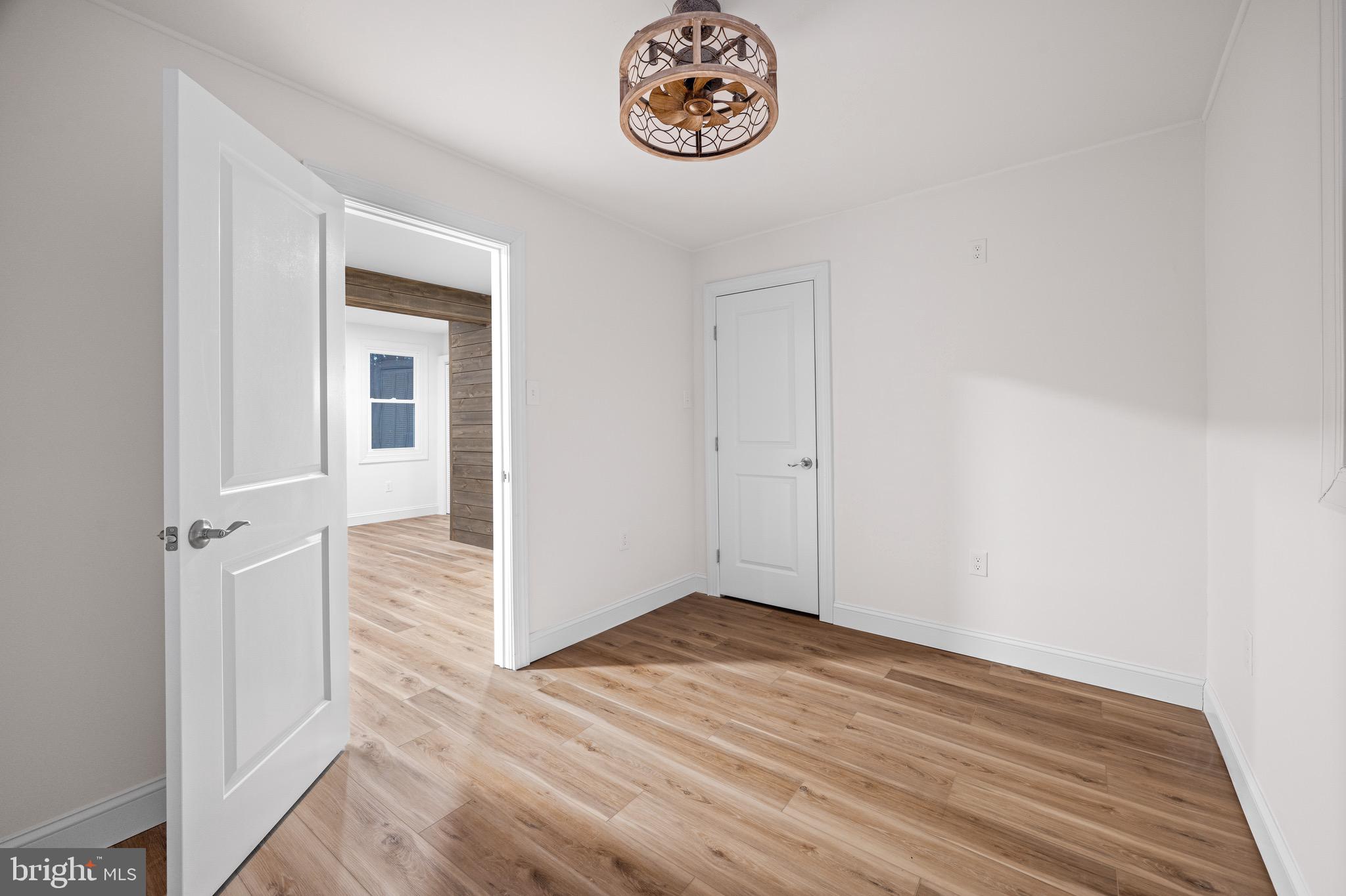 1711 Janvier Road Williamstown, NJ 08094 - Photo 7 of 24 an empty room with wooden floor and windows
