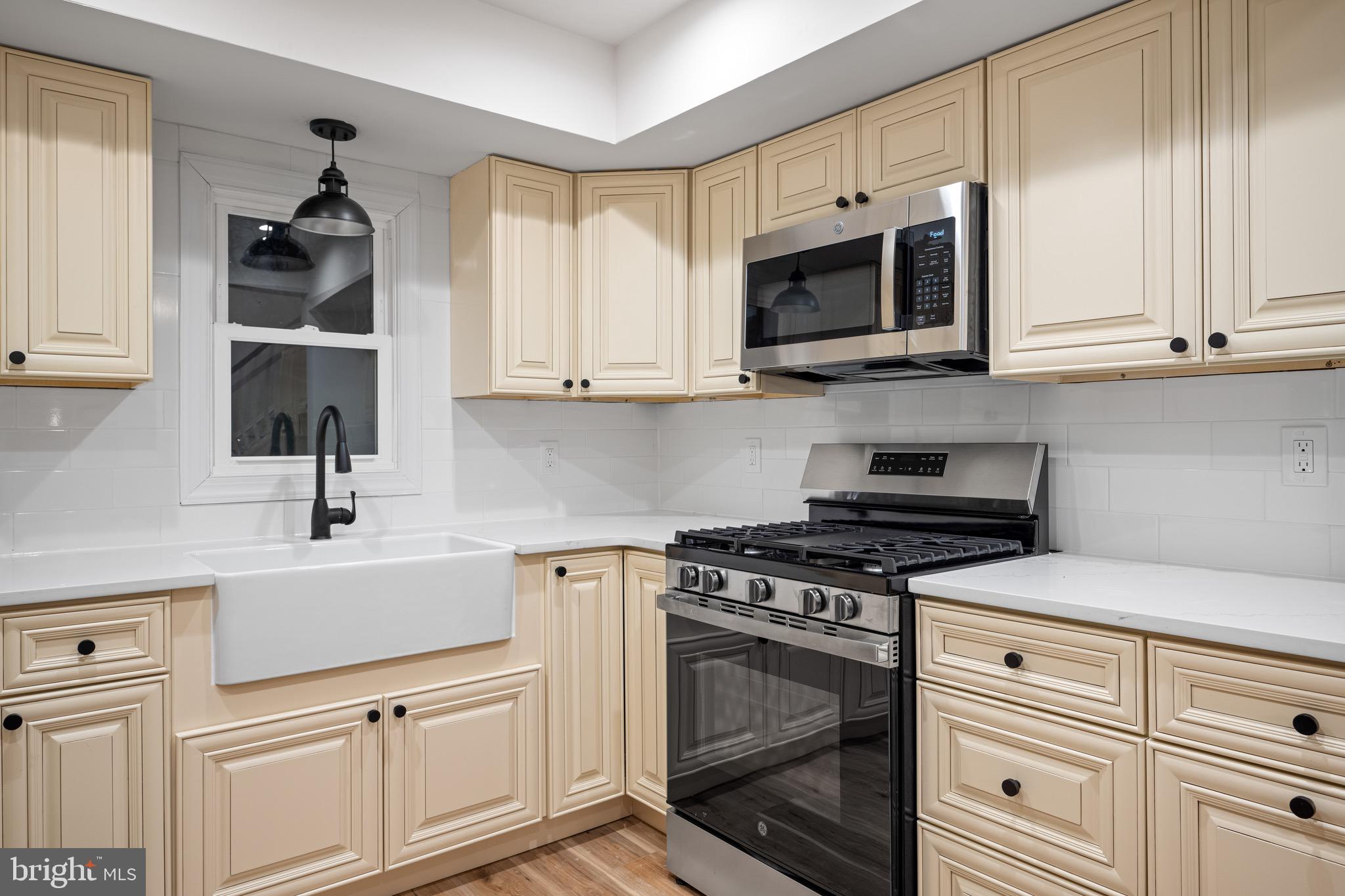 1711 Janvier Road Williamstown, NJ 08094 - Photo 10 of 24 a kitchen with white cabinets and stainless steel appliances