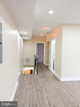 a view of a room with wooden floor and a window