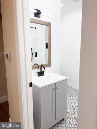 a bathroom with a sink a mirror and shower