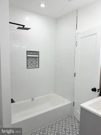 a bathroom with a bathtub a sink a toilet and a shower