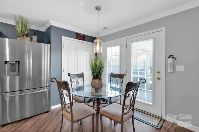 a dining room with furniture window and wooden floor