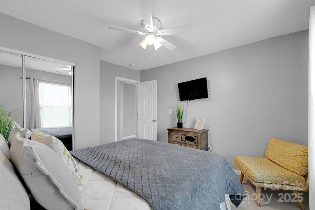 a bedroom with a bed and a television