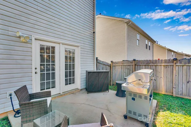 a view of backyard with outdoor seating and plants