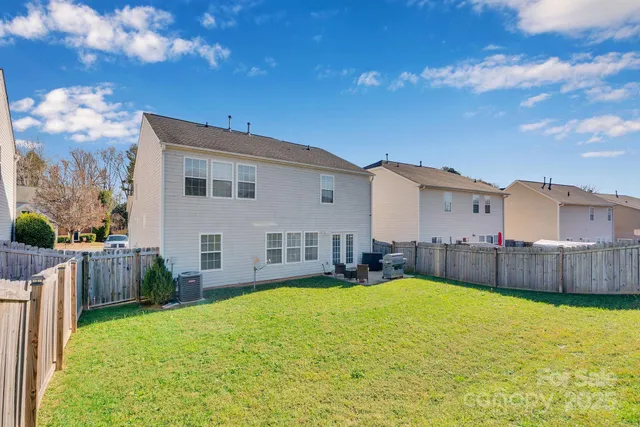 a view of a house with a big yard and potted plants