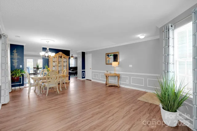 a dining room with furniture and wooden floor