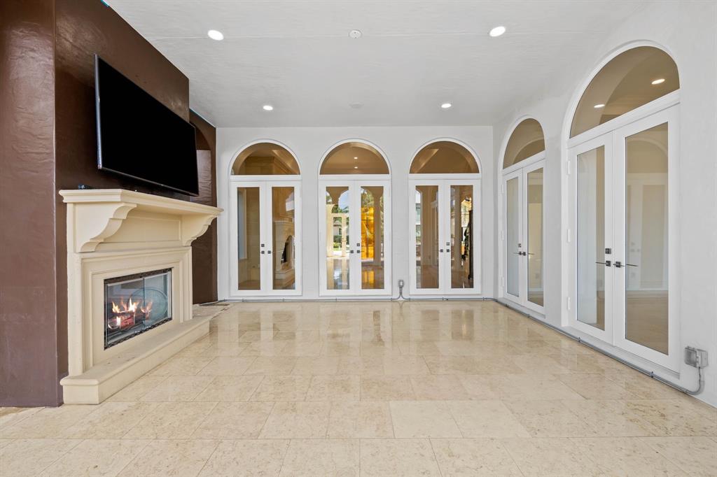 861 Nafa Drive Boca Raton, FL 33487 - Photo 12 of 54 a view of livingroom with fireplace flat screen tv and outdoor view