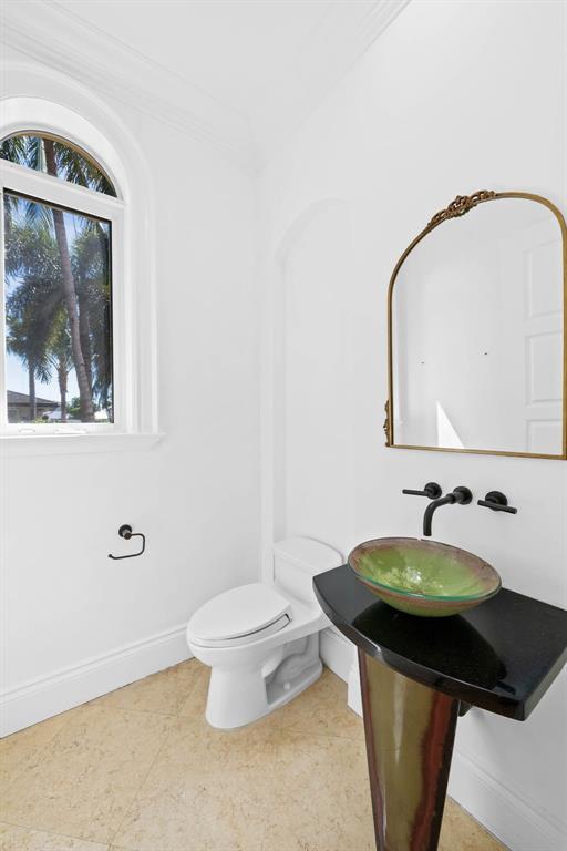861 Nafa Drive Boca Raton, FL 33487 - Photo 15 of 54 a bathroom with a toilet sink and mirror