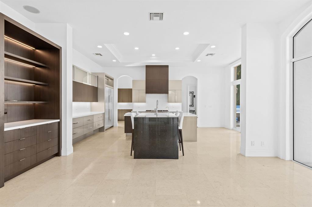 861 Nafa Drive Boca Raton, FL 33487 - Photo 27 of 54 a large white kitchen with kitchen island a sink a stove and a refrigerator