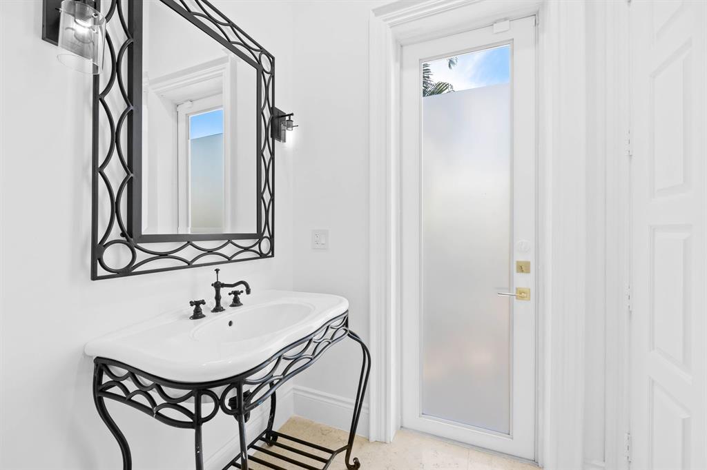 861 Nafa Drive Boca Raton, FL 33487 - Photo 28 of 54 a bathroom with a sink a mirror and a shower