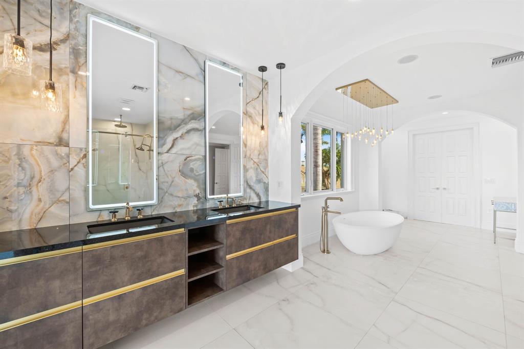 861 Nafa Drive Boca Raton, FL 33487 - Photo 49 of 54 a bathroom with a double vanity sink toilet and a tub