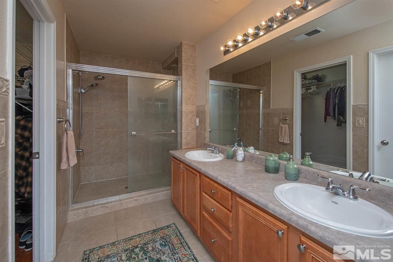 7718 Welsh Drive Reno, NV 89506 - Photo 15 of 25 a bathroom with double sink and a mirror