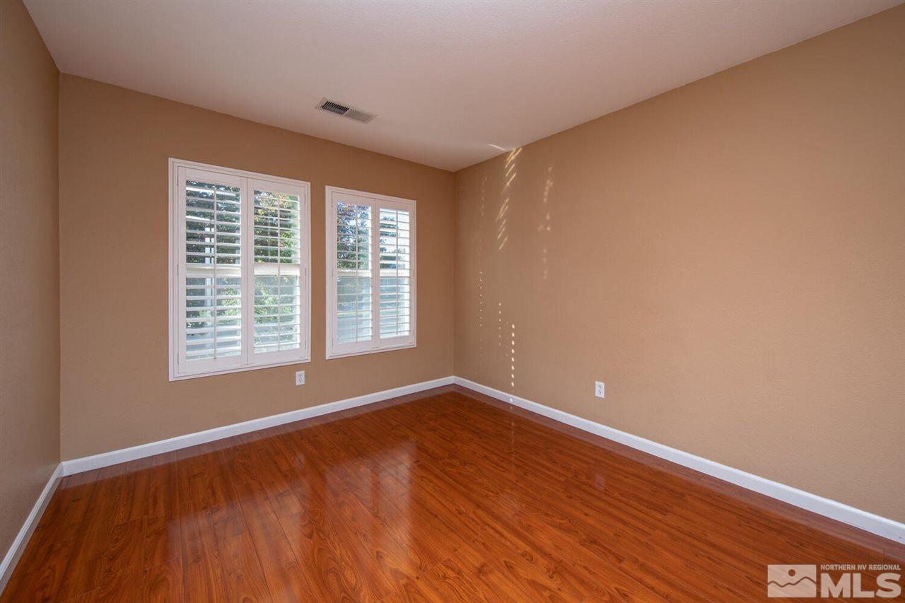 7718 Welsh Drive Reno, NV 89506 - Photo 3 of 25 a view of an empty room with a window and wooden floor