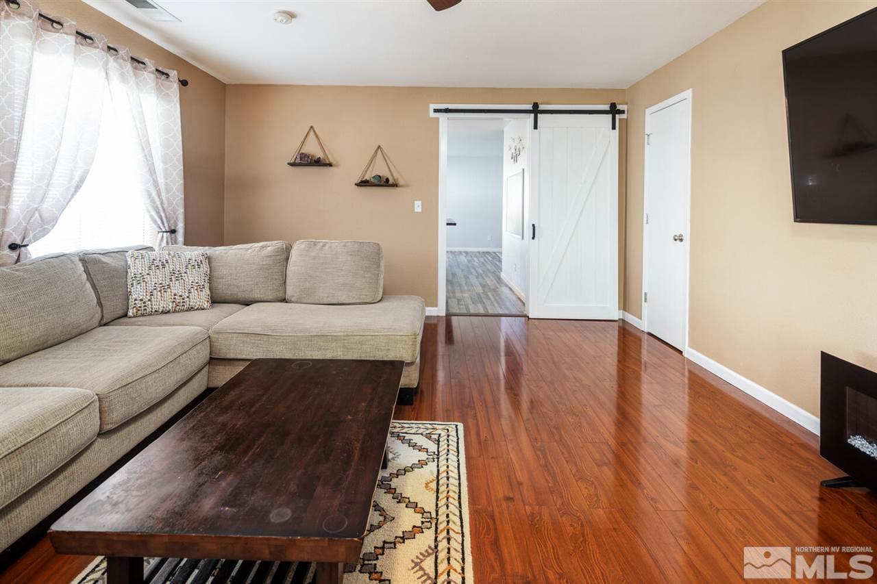 7718 Welsh Drive Reno, NV 89506 - Photo 6 of 25 a living room with furniture and a flat screen tv