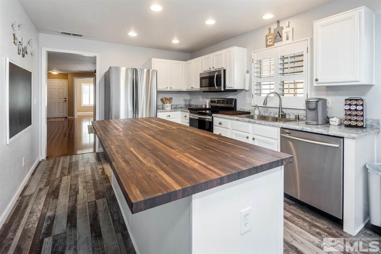7718 Welsh Drive Reno, NV 89506 - Photo 10 of 25 a kitchen with wooden cabinets and stainless steel appliances