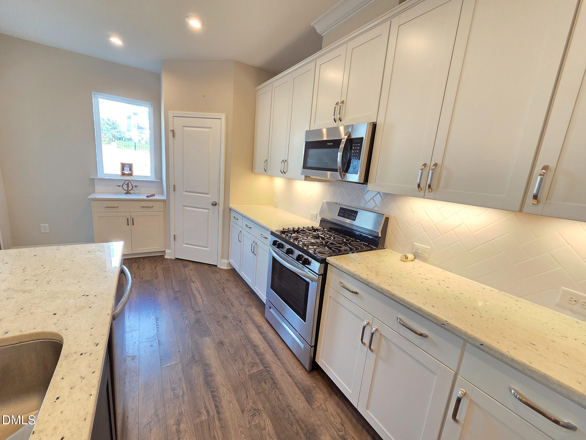 3008 Dunnock Drive Durham, NC 27713 - Photo 14 of 27 a kitchen with stainless steel appliances granite countertop a sink stove and refrigerator