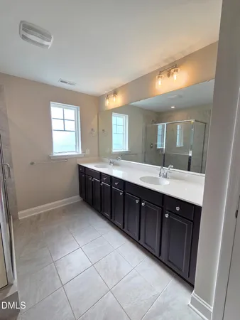 a spacious bathroom with a double vanity sink mirror and