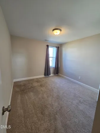 an empty room with a empty space and windows