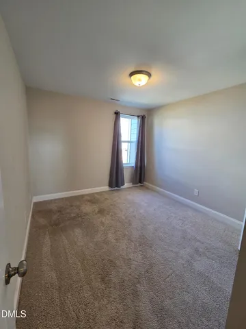 an empty room with a empty space and windows