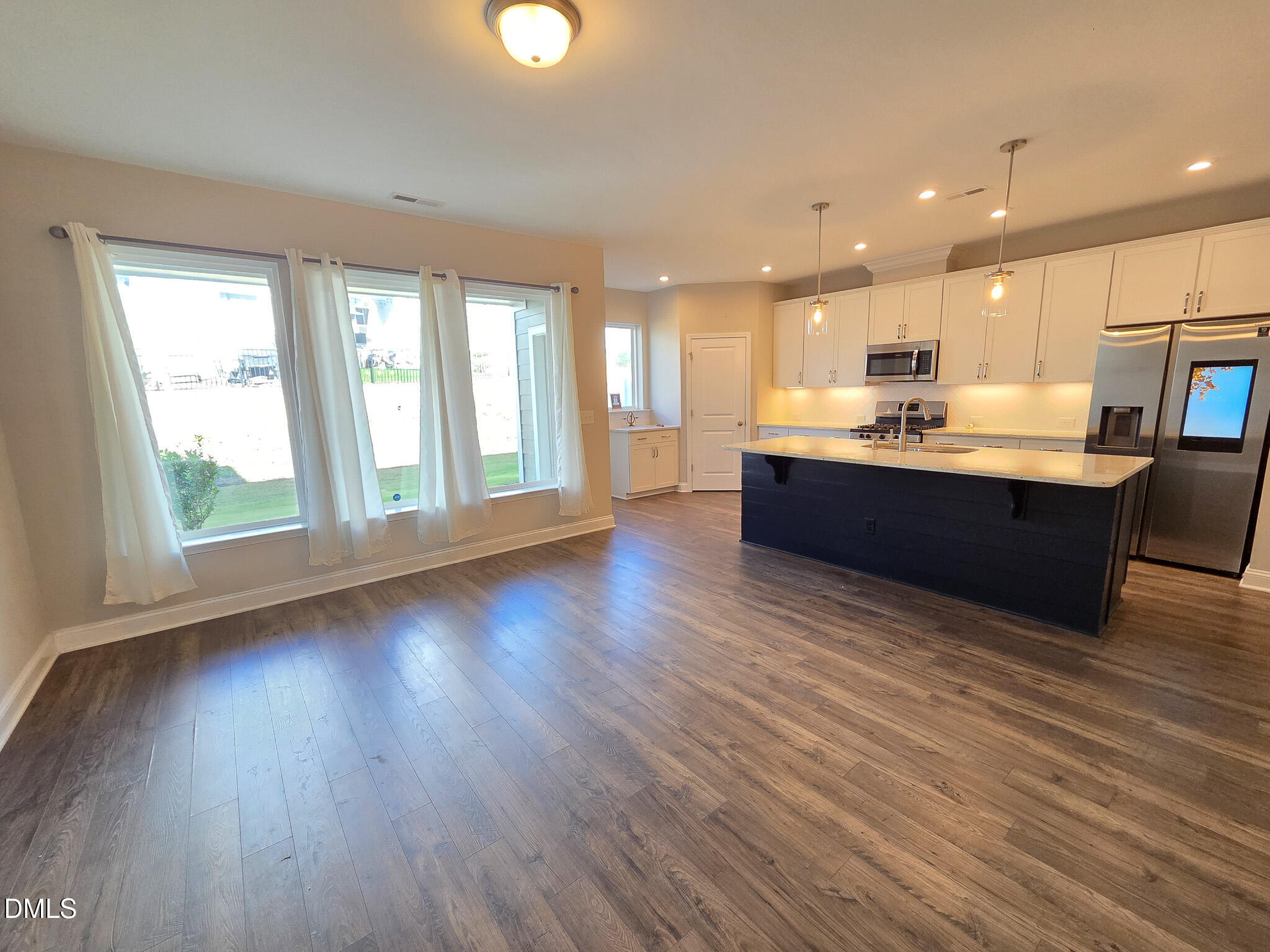 3008 Dunnock Drive Durham, NC 27713 - Photo 3 of 27 a big room with wooden floor and windows