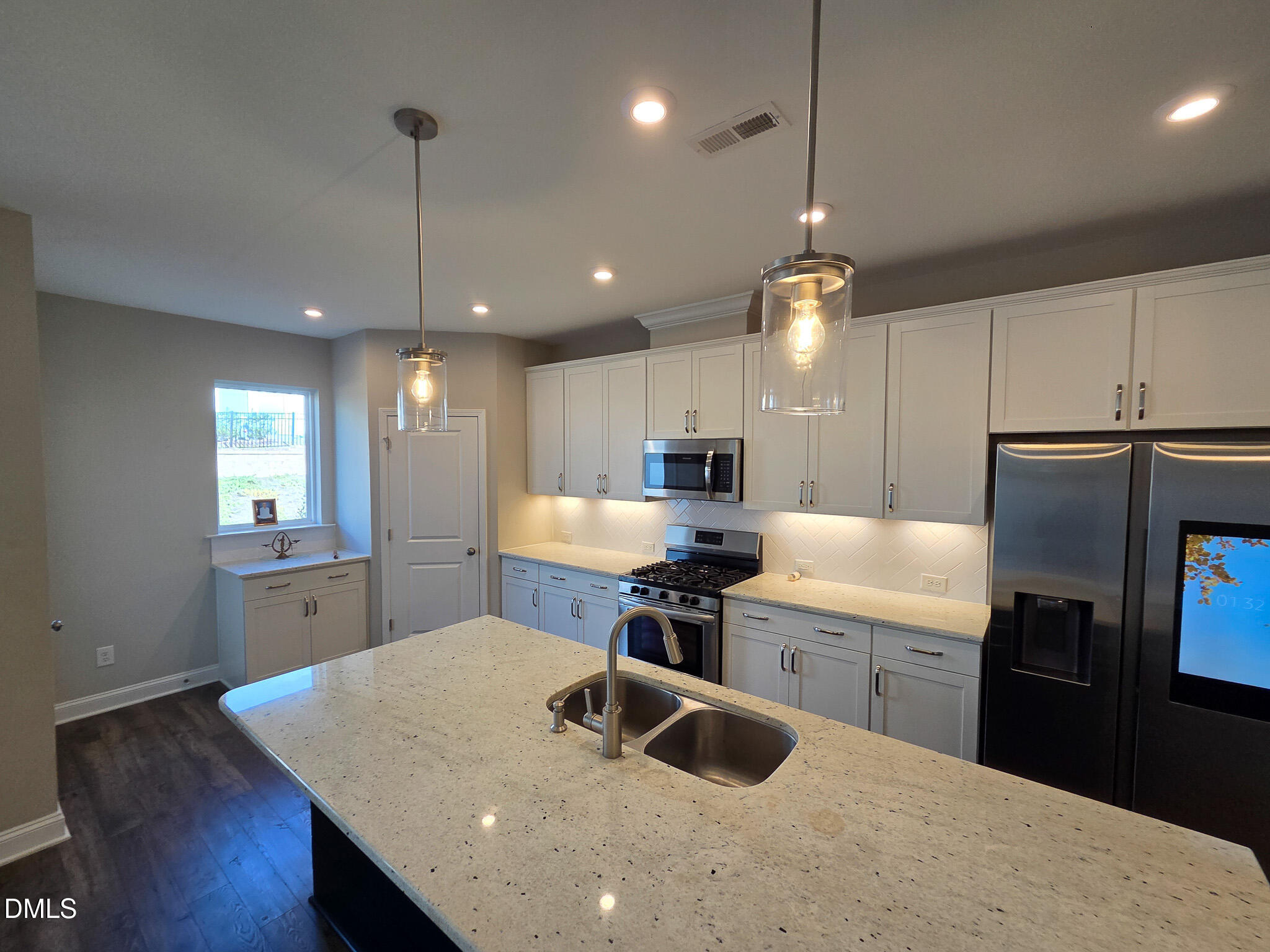 3008 Dunnock Drive Durham, NC 27713 - Photo 7 of 27 a kitchen with stainless steel appliances granite countertop a sink a stove a refrigerator a center island a dining table and chairs