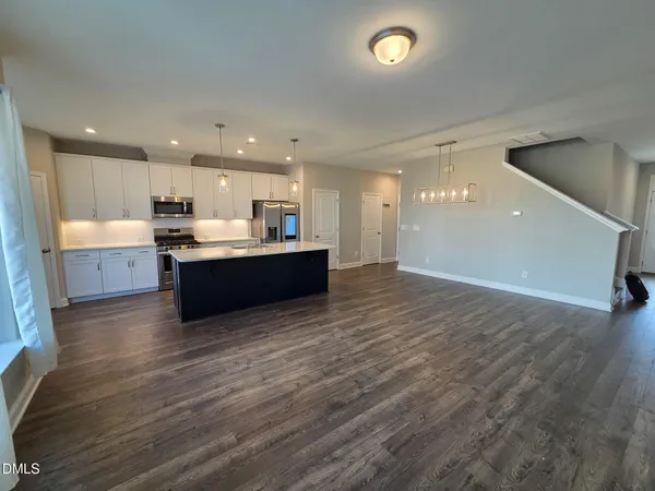 a view of kitchen and kitchen with granite countertop