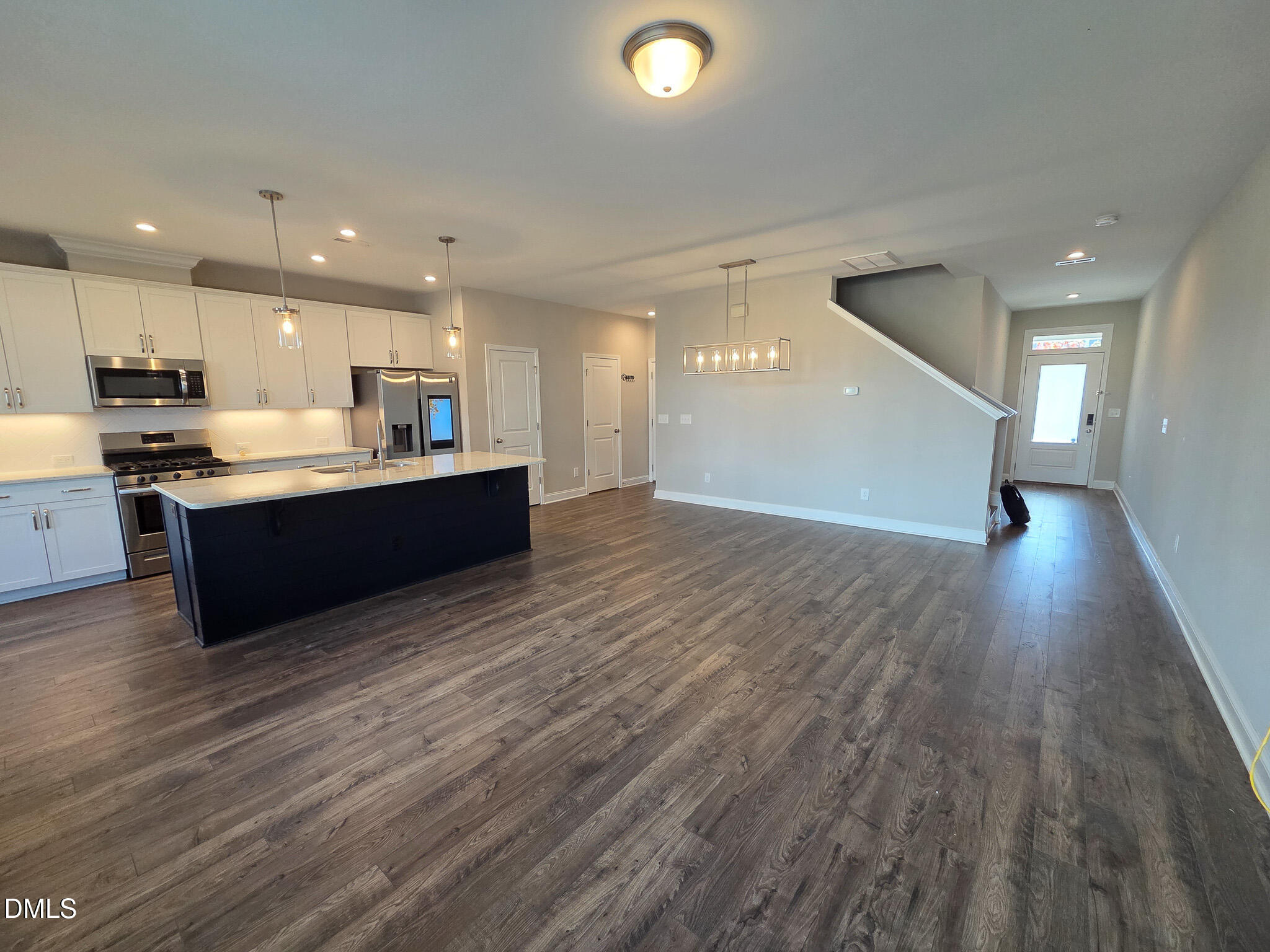 3008 Dunnock Drive Durham, NC 27713 - Photo 9 of 27 a view of kitchen with kitchen island wooden floors and stainless steel appliances