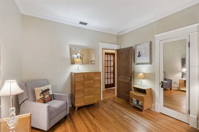 a bedroom with furniture and a wooden floor