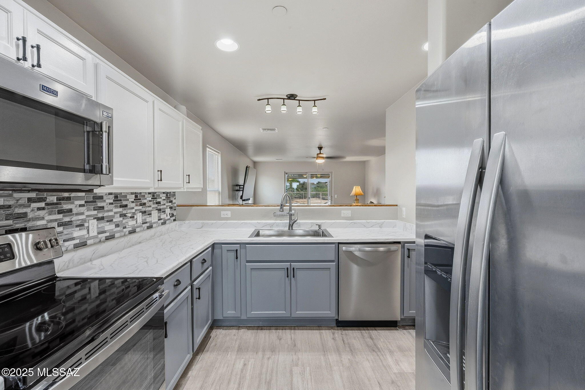 1458 North Wentworth Road Vail, AZ 85641 - Photo 27 of 44 a kitchen with a sink stove and refrigerator