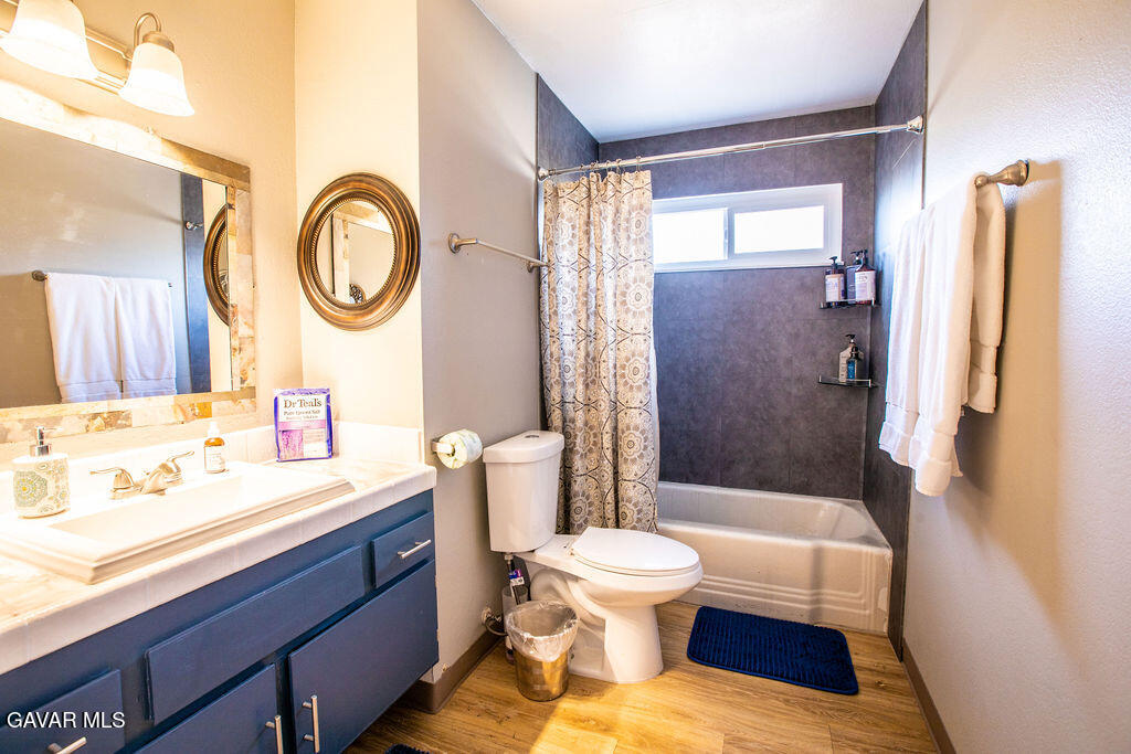 349 South Margalo Street Ridgecrest, CA 93555 - Photo 12 of 14 a bathroom with a sink a toilet and a large mirror