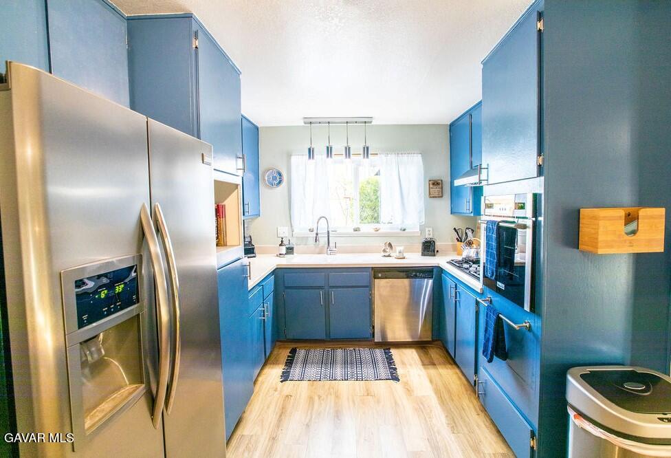 349 South Margalo Street Ridgecrest, CA 93555 - Photo 5 of 14 a kitchen with stainless steel appliances granite countertop a refrigerator a stove and a sink